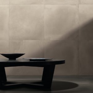 A coffee table and walls with Leonardo Ceramica Factory Tiles